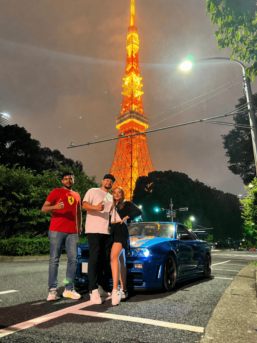 Guests with a blue Nissan Skyline GT-R R34 at Tokyo Tower