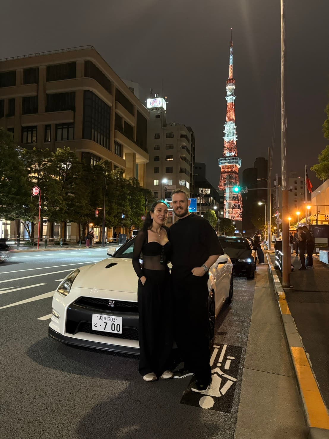 Couple with a Nissan GT-R R35 near Tokyo Tower