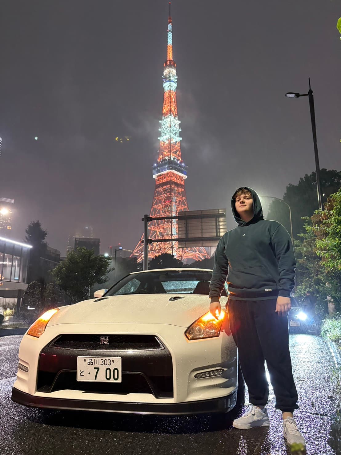 Guest with a Nissan GT-R R35 at Tokyo Tower on a rainy night